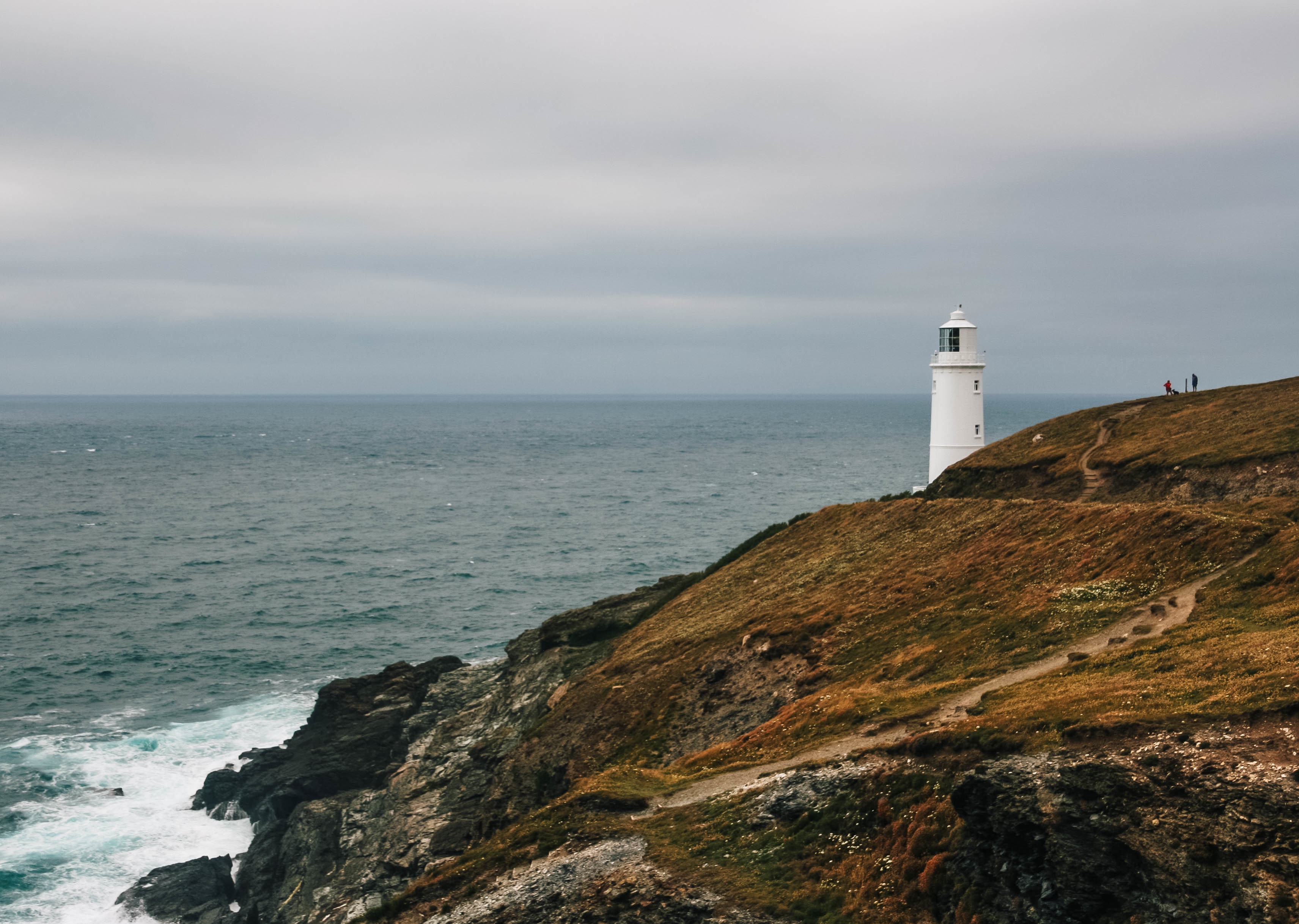Lighthouse on hill by ocean